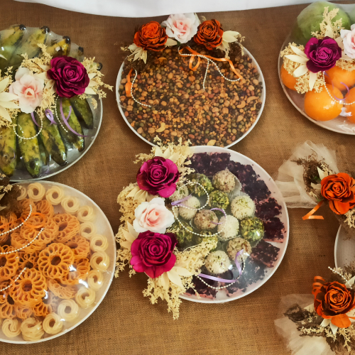 Assorted circular food trays with sweets and savouries