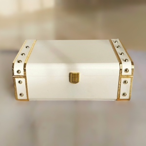 Rectangular white box with gold corners and gold lock