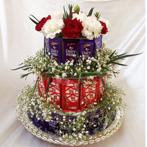 Small Tower of Dairymilk, Kitkat chocolates and Flowers for ornamentations