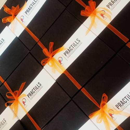 Black gift boxes with orange bow and Practills logo