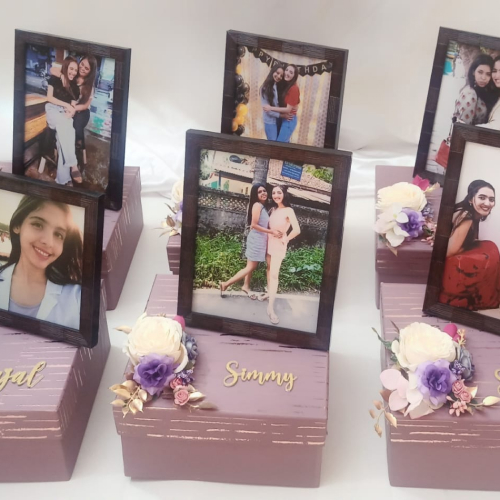 Two photo frames on top of a lavender coloured box with the Name Simmy highlighted in gold