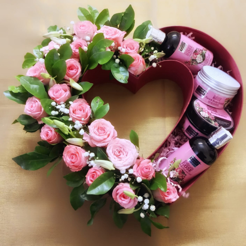 heart shaped box with violet colour toiletries and flower garland