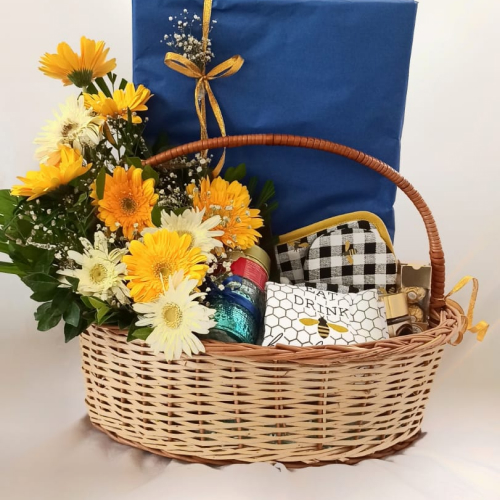 Gift basket with Assorted gifts, and white and yellow flowers